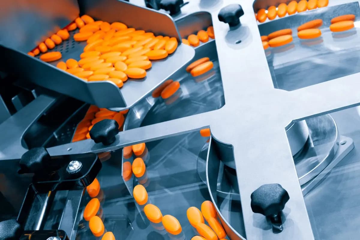 Pharmaceutical production line running tablets along a conveyor